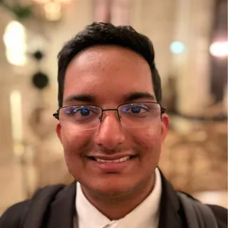 Bhargav Sampathkumaran smiling and wearing glasses