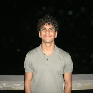 Rohan Bhatia smiling outdoors at night