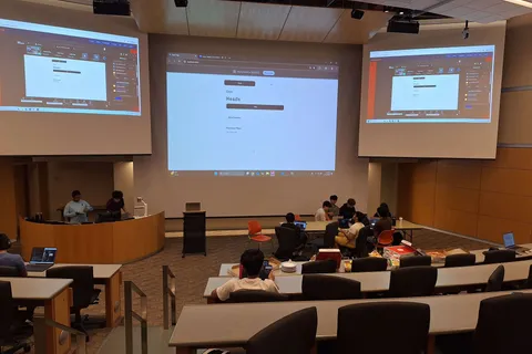 A coin flip prediction market demo projected for the audience during a live event