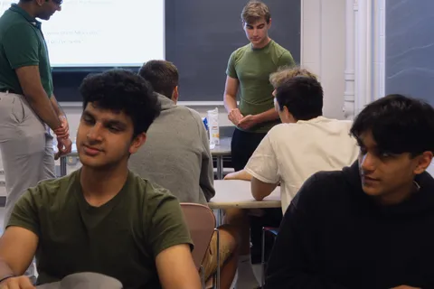 A SIGecom lead presenting the club's welcome slide to members seated in a classroom