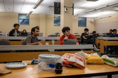 SIGecom members chatting during a meeting with snacks laid out